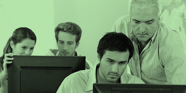male-teacher-male-student-at-computer